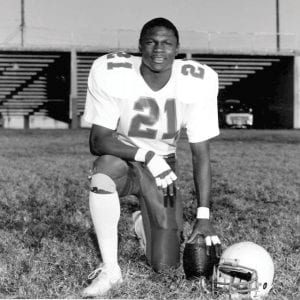 Anthony Grigsby The Howard School class of 1987 kneeling on a football field in the chattanooga area