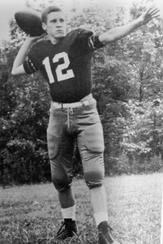black and white image of football player throwing