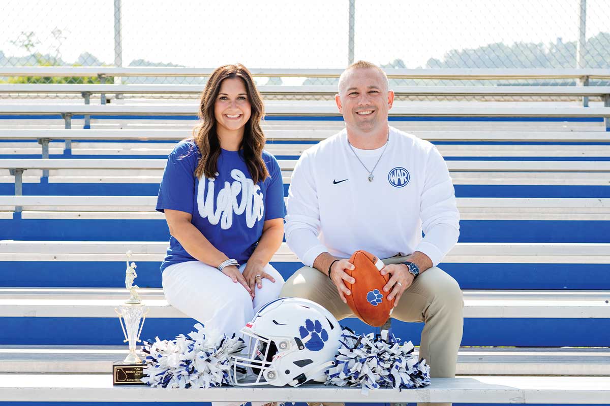 couple smiling on bleachers