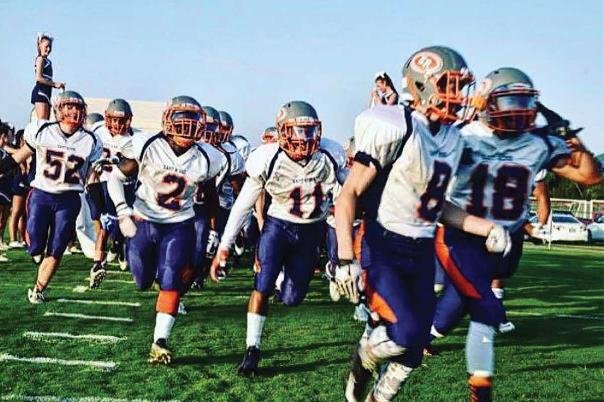 football players walking on field