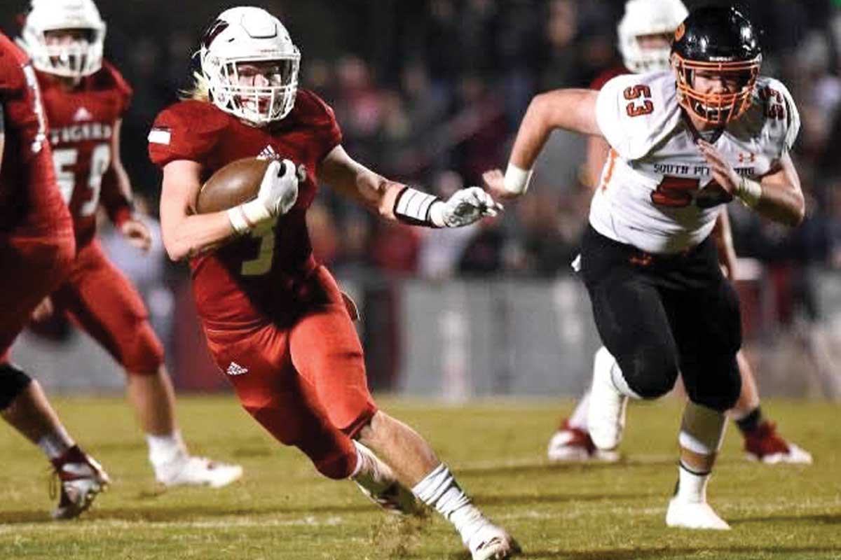 Football player running with ball.